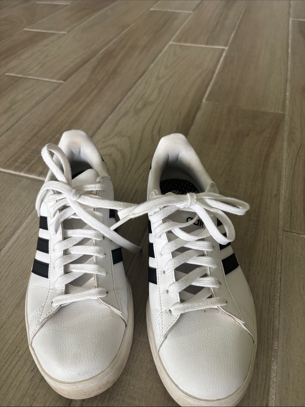 Adidas woman’s White Sneakers with Black Stripes